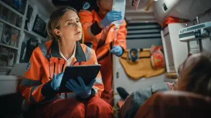 an emergency response nurse recording patient details using an SBAR template on a tablet