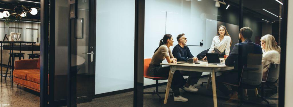 enterprise employees collaborating in a meeting room and using an enterprise collaboration software