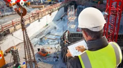 a construction supervisor assessing risks involved in working at heights and how to implement risk avoidance strategies