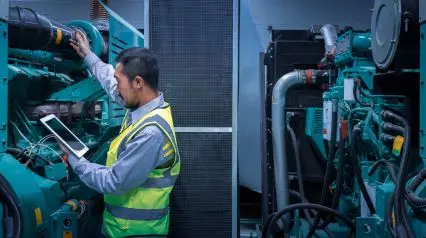 a machinery operator inspecting a factory machinery before operation using a machinery pre start checklist