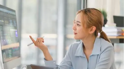 an operations manager and analyst looking at data gathered using an operational audit checklist on a desktop