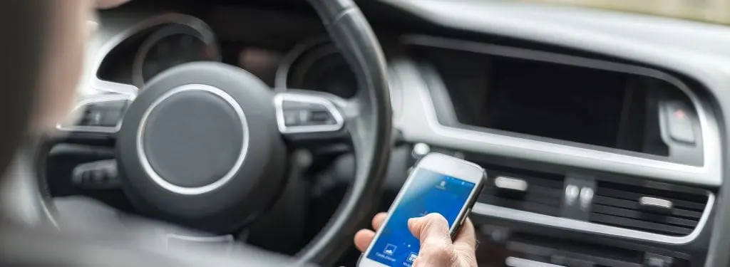 a driver checking safety measures using a road safety app on a mobile|Drivemode Road Safety App|Google Maps Road Safety App|Life360 Road Safety App|Sygic GPS Navigation Road Safety App|Waze Road Safety App