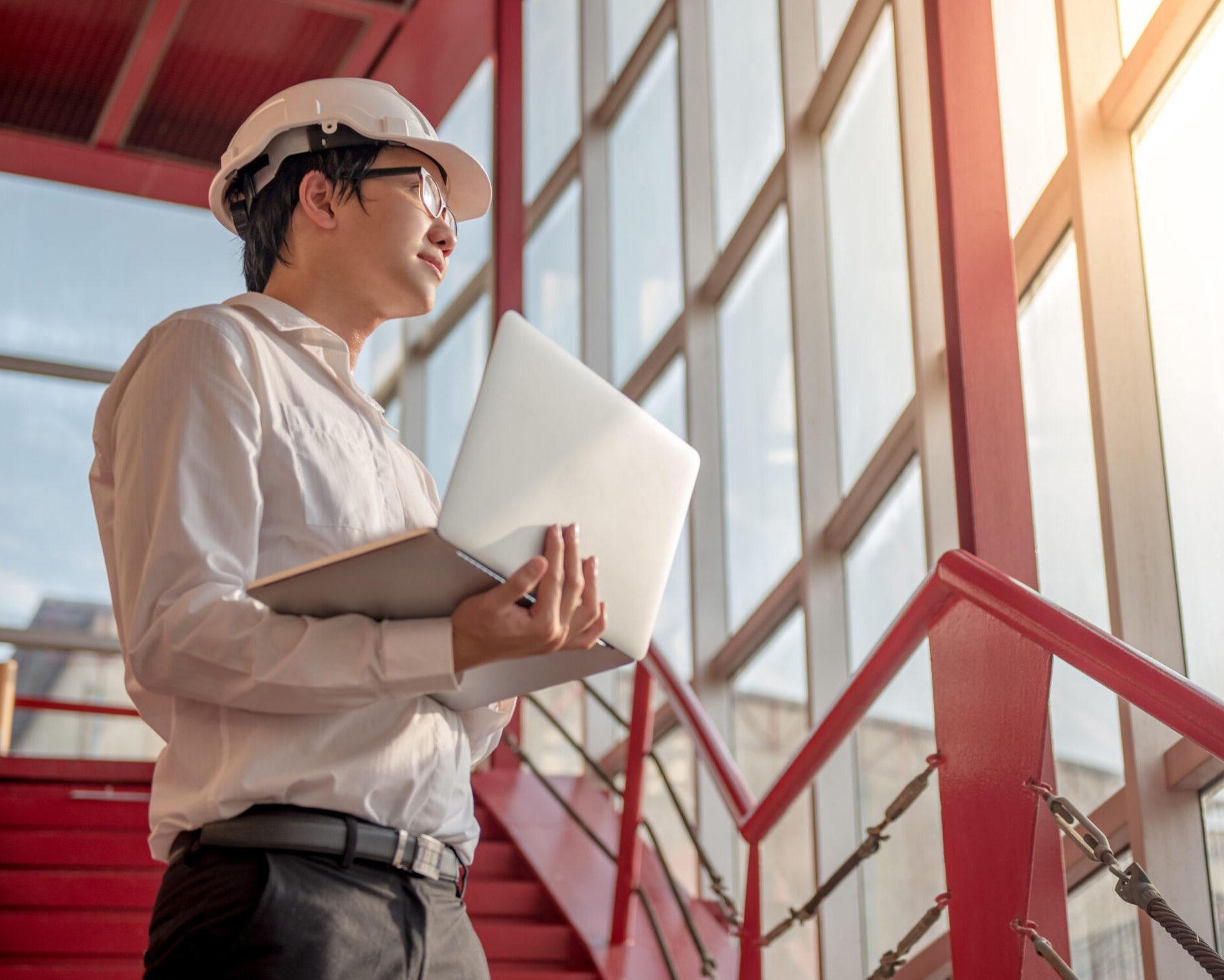 a construction project manager using a project portfolio management software for enterprise on a laptop