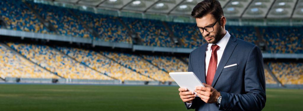 a sports event organizer using a sports event management software on a tablet