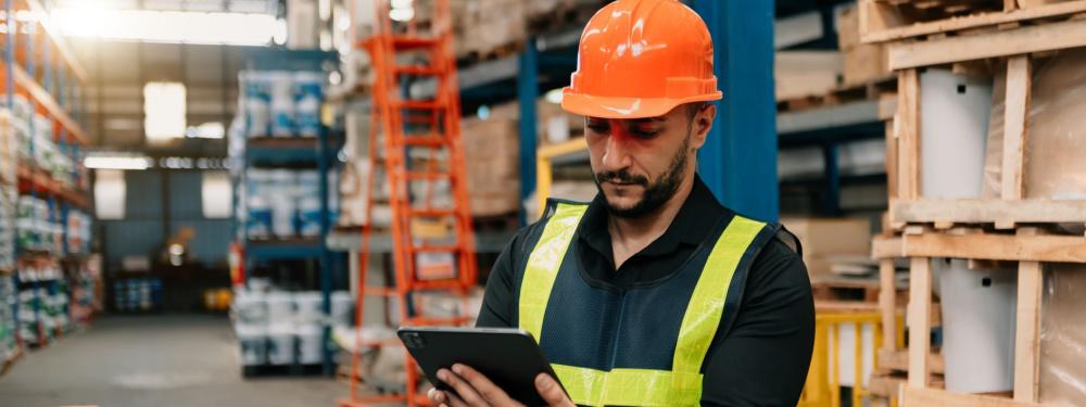 a professional using enterprise management software on tablet