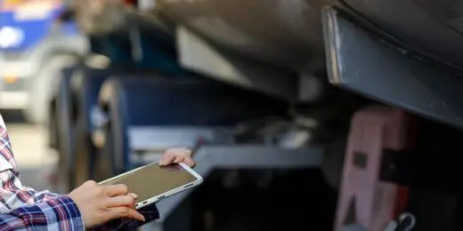 a driver inspecting a vehicle using a DVIR form on tablet