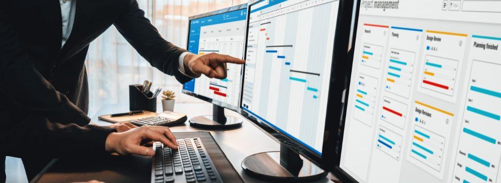 two project managers organizing task workflows using an enterprise workflow software on desktop