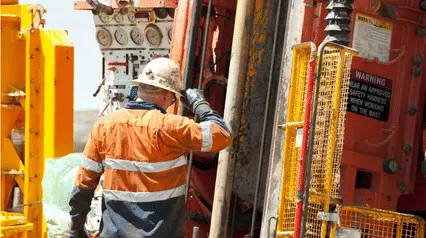 construction worker drilling a construction site with a core drill