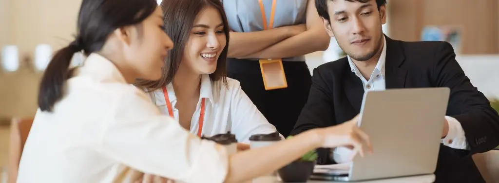 employees at work using data driven decision making tools on a laptop