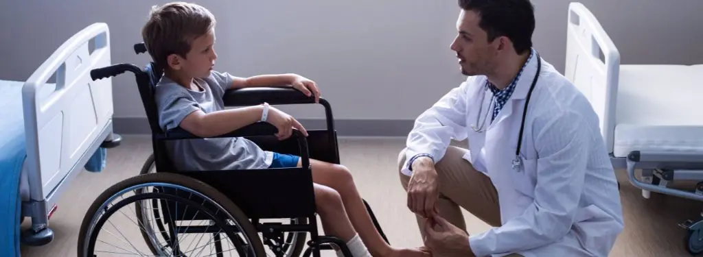 a medical doctor attending to a patient before using an NDIS software to recording information