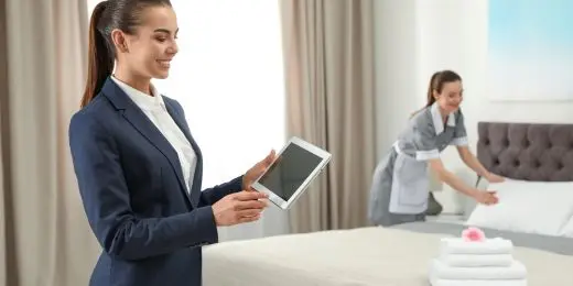 hotel workers complying with lqa standards as described in a tablet