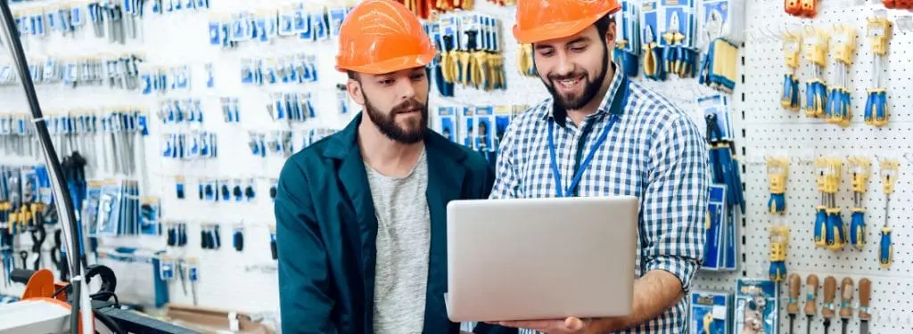 two construction engineers checking their project's tool needs using a tool management software on a laptop|EZOfficeInventory Tool Management Software|Fiix Tool Management Software|ToolHound Tool Management Software|Tooltribe Pro Tool Management Software|ToolWatch Tool Management Software|UpKeep Tool Management Software