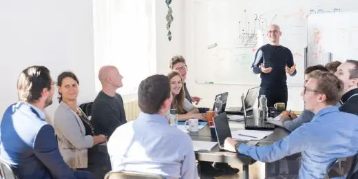 a group of safety professionals conducting a risk management training session in an office setting