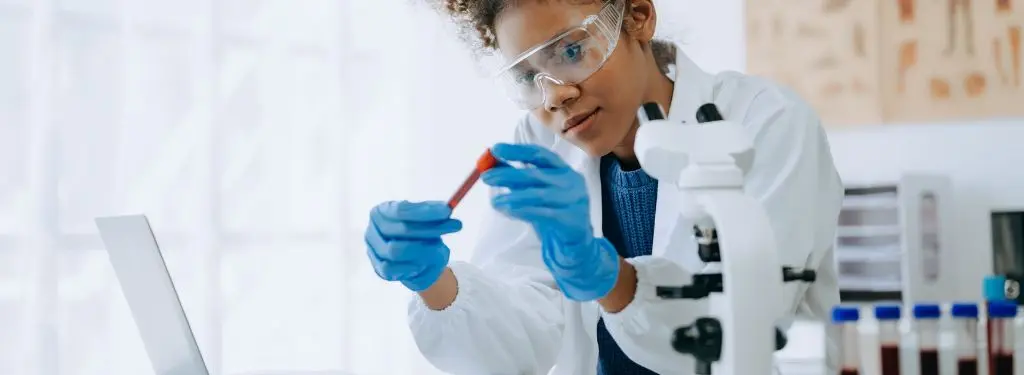 a laboratory technician testing samples as guided by an ISO 17025 software on laptop